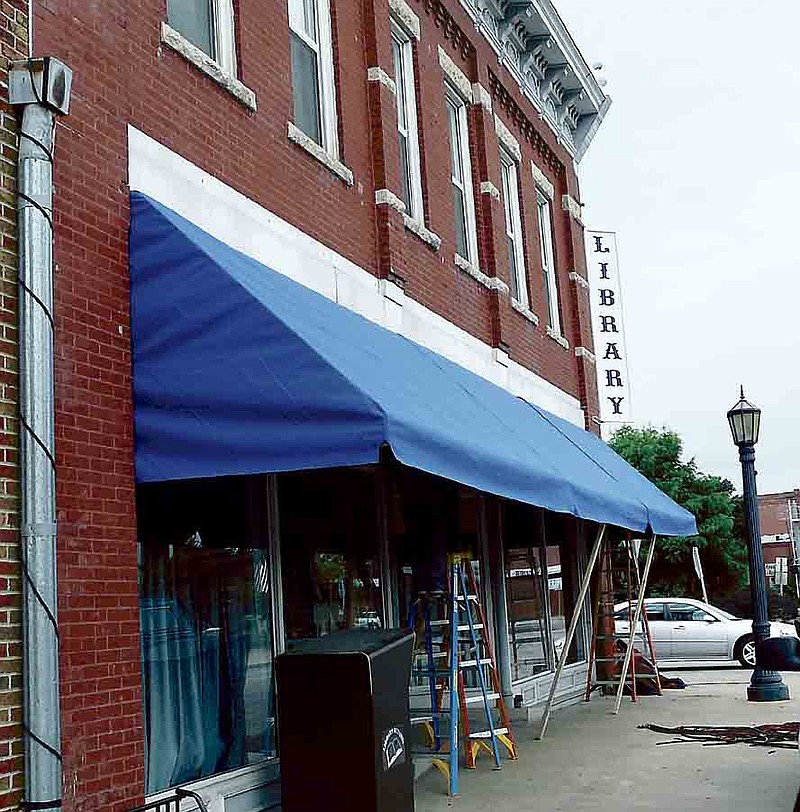 A beautiful blue awning is installed at the Moniteau County Library @ Wood Place on Thursday, Aug. 8, 2013.