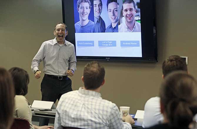 This photo taken Aug. 6, 2013 shows Brad Karsh of JB Training Solutions speaking to a group of generation X'ers at the Hu-Friedy Manufacturing Co. in Chicago. There's a new urgency to the quest for workplace harmony, as baby boomers delay retirement and work side-by-side with people young enough to be their children - or grandchildren. 