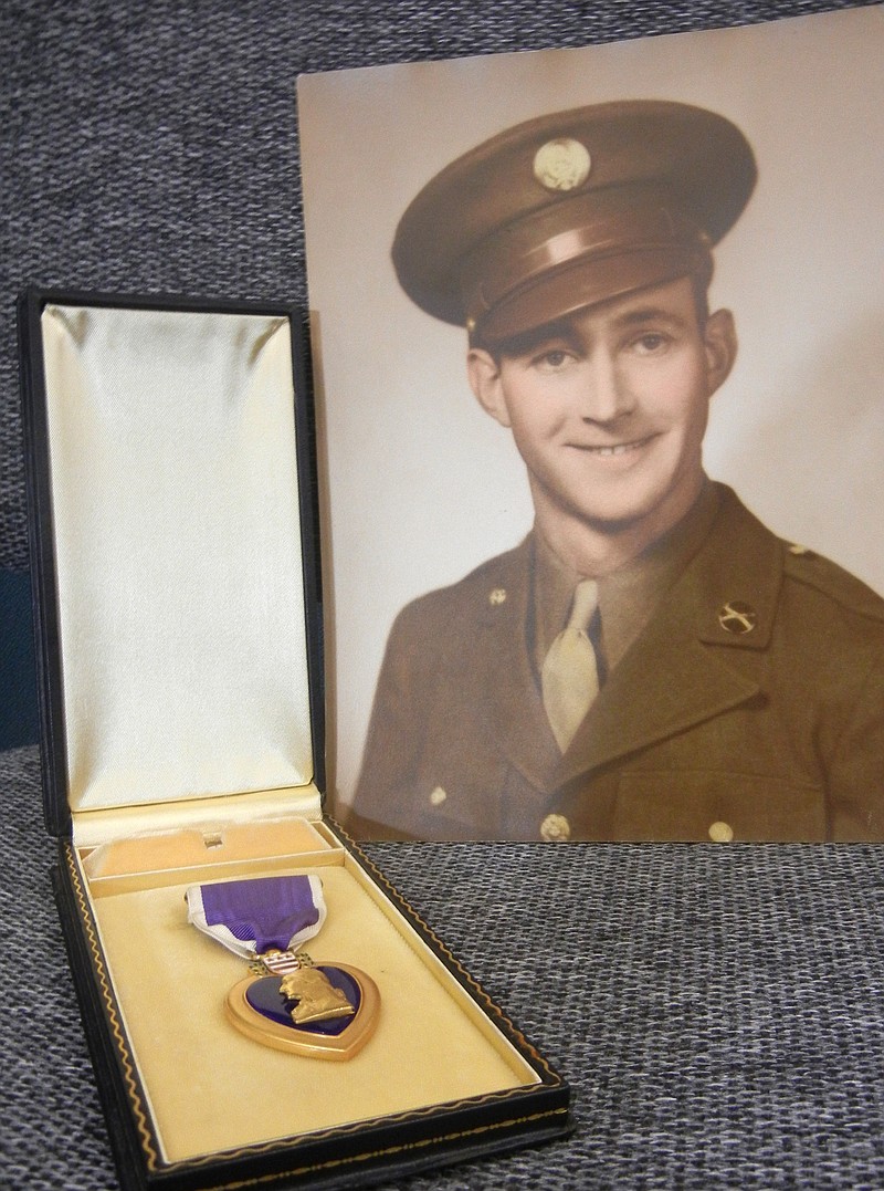 Pvt. James Roland and the Purple Heart medal he earned serving in World War II is shown here June 28. The medal was found by Goodwill employee Richard Zuehlke while unpacking donations. The medal will be presented to Roland's cousin, Mary Roland Struble, on Saturday during a ceremony in Westover, Pa.