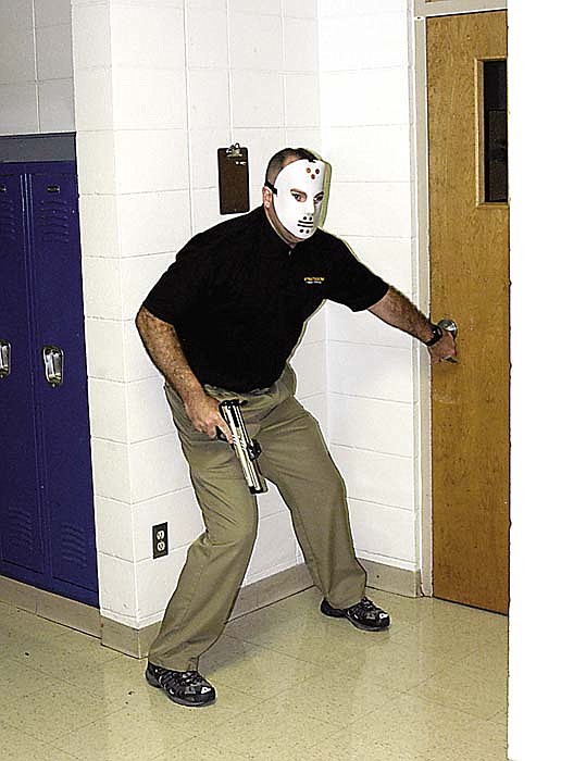 Security instructor Bill Oliver portrays an armed intruder in a scenerio at California High School on Friday, Aug. 9, part of the school safety training for the California R-I School staff.
