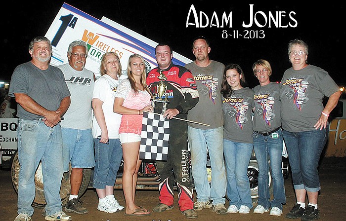 Adam Jones, Wright City, celebrates his 360 Winged Sprint feature win Sunday night at the Double-X Speedway, California. Presenting Jones' trophy is Speedway Trophy Girl Kelsey Brauner, California.