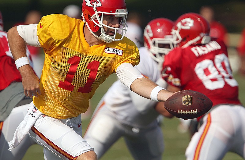 Chiefs quarterback Alex Smith looks to hand the ball off during training camp Wednesday in St. Joseph.