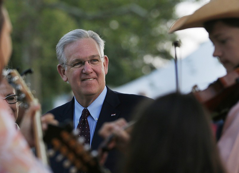 Missouri Gov. Jay Nixon watches The Baker Family perform at the Governor's Ham Breakfast at the Missouri State Fair in Sedalia on Thursday.