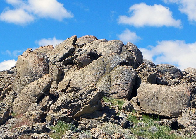 This 2012 photo provided by the Nevada State Museum shows ancient carvings on limestone boulders near Nevada's Pyramid Lake which have been confirmed to be the oldest recorded petroglyphs in North America - at least 10,500 years old. Larry Benson, the curator of anthropology at the University of Colorado Natural History Museum, and Eugene Hattori, curator of anthropology at the Nevada State Museum, were among the co-authors of a paper on the findings published this month in the Journal of Archaeological Science. This site was once the shoreline of the now dried up Winnemucca Lake. 