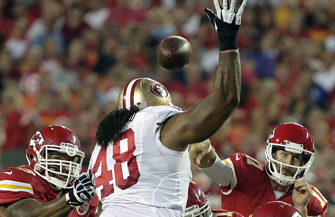 Chiefs quarterback Alex Smith throws past 49ers defensive tackle Will Tukuafu during the first half of Friday night's preseason game at Arrowhead Stadium.