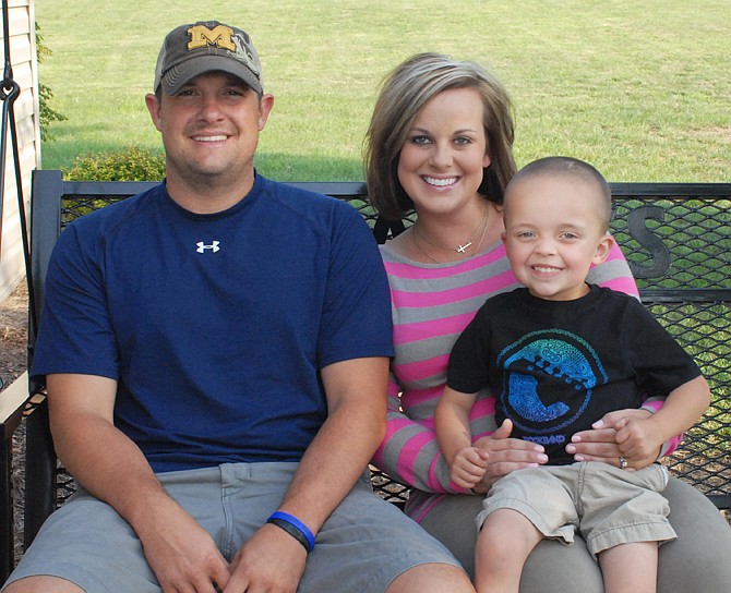 Dustin and Jennifer Backes sit with their 3-year-old son, Hayden. A benefit will be held Aug. 24 in honor of Hayden, who suffers from neurofibromatosis.