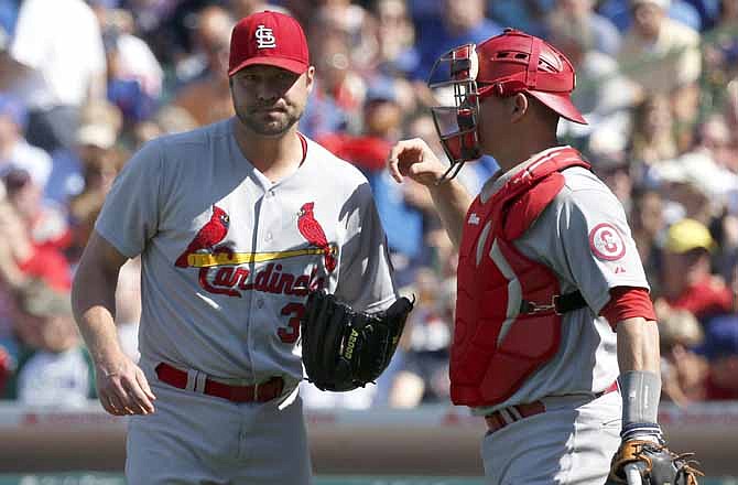 St. Louis Cardinals catcher Rob Johnson, right, visits starting pitcher Jake Westbrook on the mound during the first inning of a baseball game against the Chicago Cubs on Friday, Aug. 16, 2013, in Chicago. 