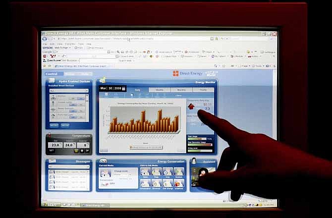 In this 2008 file photo, George Tsapoitis displays an online usage and utility screen connected to a electric smart meter in his Milton home in Milton, Canada. Some electric companies are increasingly offering customized pay plans, made easier by the growing use of digital meters that wirelessly link electric companies and customers.