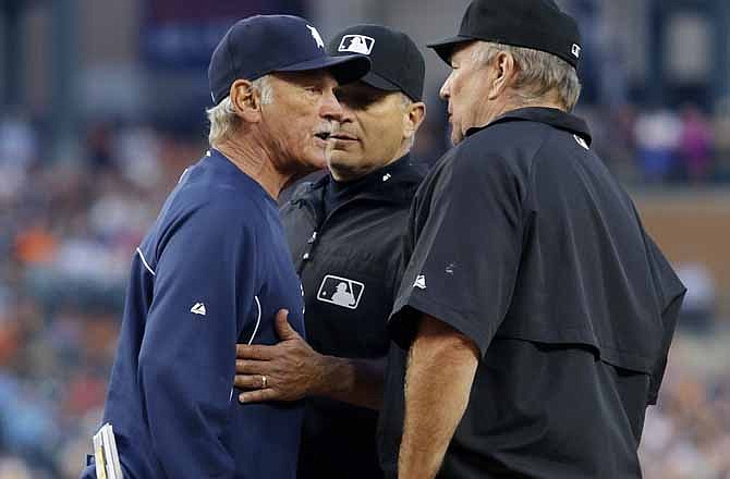 Detroit Tigers manager Jim Leyland, left, is restrained by second base umpire John Hirschbeck, center, as he argues with first base umpire Bob Davidson after being ejected from the game in the fourth inning of a baseball game, Saturday, Aug. 17, 2013, in Detroit. Leyland had come out to argue a call and was ejected after returning to the dugout.