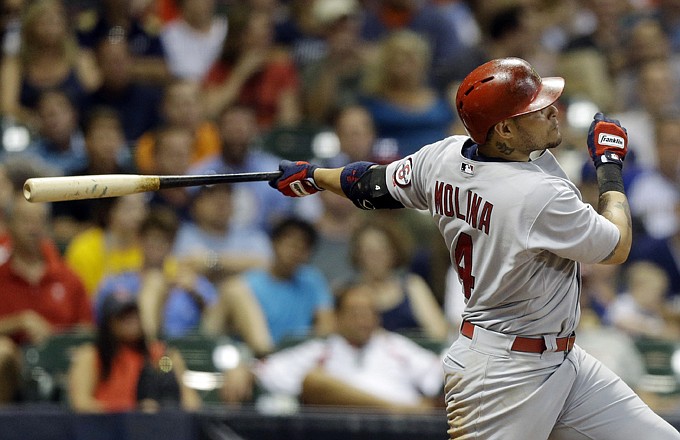 Yadier Molina of the Cardinals watches his two-run home run in the fourth inning of Tuesday night's game against the Brewers in Milwaukee.