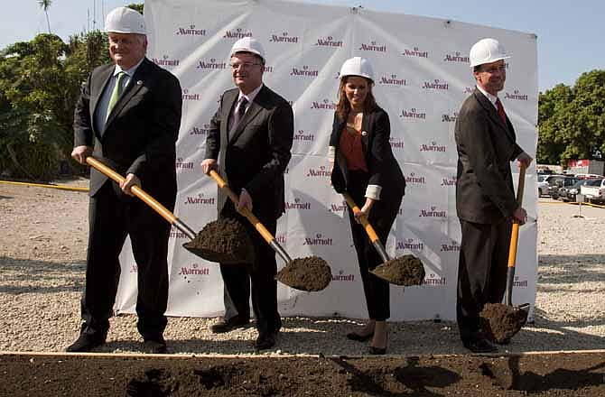 In this Dec. 19, 2012 file photo, Denis O'Brien, chairman of Digicel Group, left, Digicel Group CEO Colm Delves, second from left, Haiti's Tourism Minister Stephanie Balmir Villedrouin, second from right, and Arne Sorenson, president and CEO of Marriott International participate in a groundbreaking ceremony for the construction of a Marriott hotel in Port-au-Prince, Haiti. For Nickson Toussaint, who returned to Haiti from Washington, D.C. with dreams of opening a small hotel along the coast north of the country's capital, the snags he's hit reflect a system that favors big, multinational companies such as Marriott International or Best Western. 