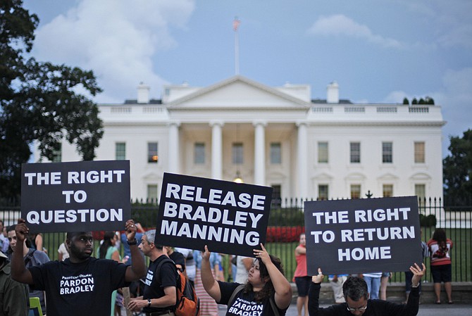 Supporters of Army Pfc. Bradley Manning, hold up signs Wednesday during a demonstration in front of the White House. Manning was sentenced earlier in the day to 35 years in prison for leaking classified information to WikiLeaks. 
