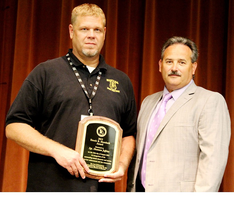 Sgt. Shannon Jeffries, left, of the Callaway County Sheriff's Office, holds a plaque naming him as the recipient of the 2013 Enoch B. Morelock Award, a statewide law enforcement award presented annually by the U.S. Attorney's Office in Kansas City. With Jeffries is Callaway County Sheriff Dennis Crane. Jeffries was honored for his work in narcotics investigation as the coordinator of the Mid-Missouri Unified Strike Team and Narcotics Group (MUSTANG). The multi-county group includes police officers from Fulton, Jefferson City and Columbia and deputies from Sheriff Departments in Callaway, Cole and Boone counties.