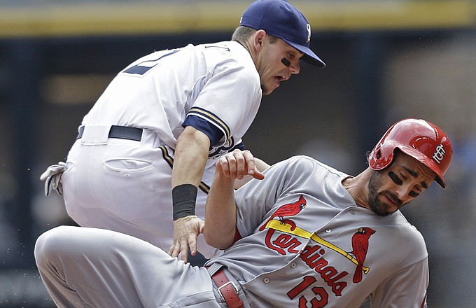 Matt Carpenter of the Cardinals steals second base as Scooter Gennett of the Brewers takes the late throw during the fourth inning of Wednesday afternoon's game in Milwaukee.