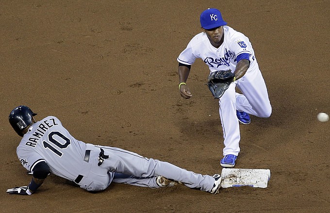 Alexei Ramirez of the White Sox beats the throw to Royals shortstop Alcides Escobar while sliding back to second base on a pickoff attempt during the fourth inning of Wednesday night at Kauffman Stadium.