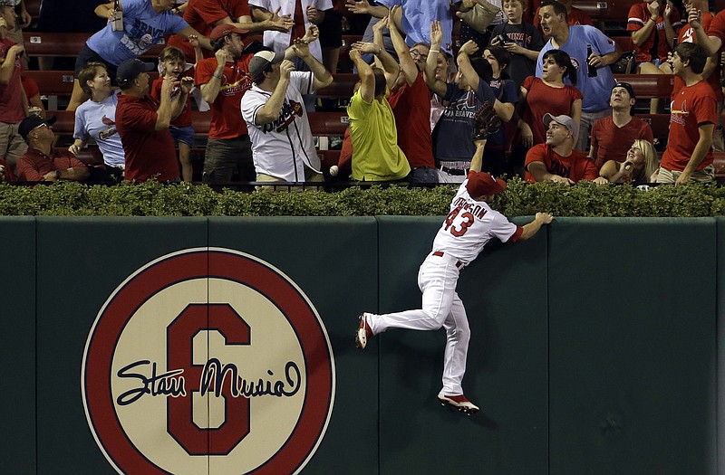 Cardinals center fielder Shane Robinson (43) cannot reach a ball hit the Braves' Justin Upton for a two-run home run during the fifth inning of Thursday's game in St. Louis.