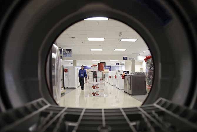 In this Dec. 6, 2012, photo, an employee walks through the appliance department at a Sears store in North Olmsted, Ohio. 