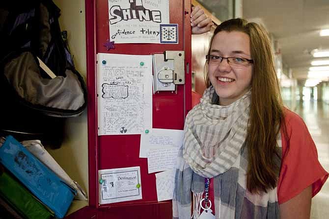 Sarah Casebeer, a junior at Northwest High School, stands at her school locker in Pleasant Lake, Mich. on June 7, 2013. When she opened the envelope containing her perfect composite score of 36 on the ACT she couldn't believe her eyes. Unlike her, almost a third of this year's high school graduates who took the ACT tests are not prepared for college-level writing, biology, algebra or social science classes, according to data the testing company released Wednesday.  (AP Photo/The Citizen Patriot, Mike Mulholland)