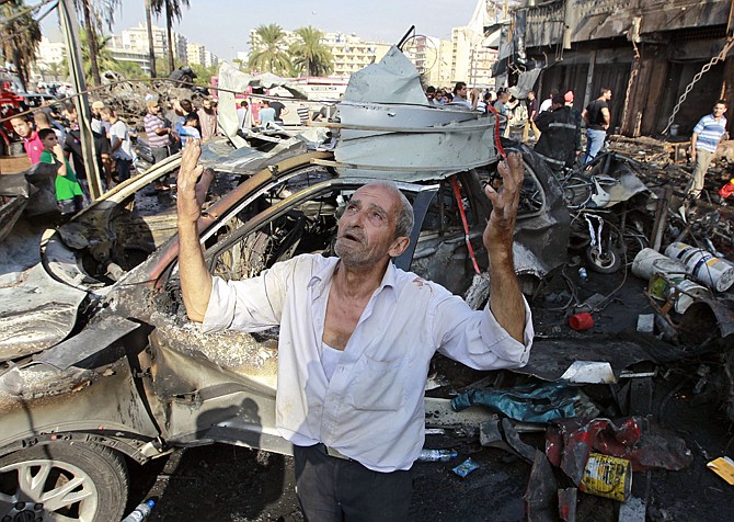 A man recites prayers Friday amid the destruction after a car bomb outside the Al-Taqwa mosque in the northern city of Tripoli, Lebanon. The twin car bombs, which killed dozens, hit amid soaring tensions in Lebanon as a result of Syria's civil war, which has sharply polarized the country along sectarian lines and between supporters and opponents of the regime of Syrian President Bashar Assad.