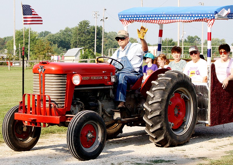 Patriotism was on parade Saturday during the annual Kingdom of Callaway Historical Society Vintage Tractor Drive along the Missouri River commemorating the flood of 1993. This Massey Ferguson 50 entry featured a U.S. flag on the front of the tractor and a bench mounted on the rear with a patriotic canopy.
