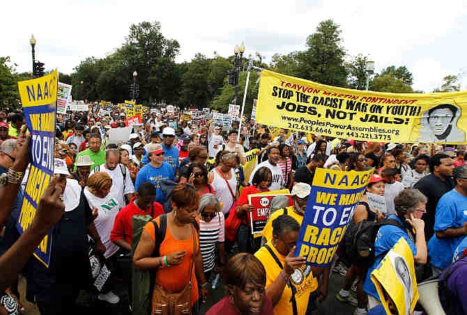 Participants march down Independence Avenue away from the Lincoln Memorial during the rally to commemorate the 50th anniversary of the 1963 March on Washington Saturday, Aug. 24, 2013, in Washington. Tens of thousands of people marched to the Martin Luther King Jr. Memorial and down the National Mall on Saturday, to commemorate King's famous ""I Have a Dream" speech, made Aug. 28, 1963.