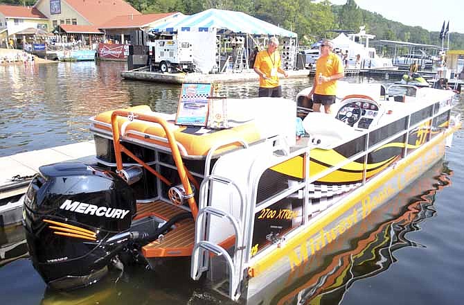 The Midwest Boats pontoon racing team of Cedar Falls, Iowa, showcases their award-winning watercraft at Captain Ron's Saturday before taking to the Shootout's time trial course later in the day. This team won first place at the Offshore Super Series-sanctioned Lake Race 2013's first-ever pontoon boat race, which was held in June in Lake Ozark near Bagnell Dam. 