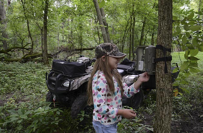 Running trail cameras is a great way to involve youth in hunting and conservation. Pictured is Brandon Butler's daughter, Bailee.