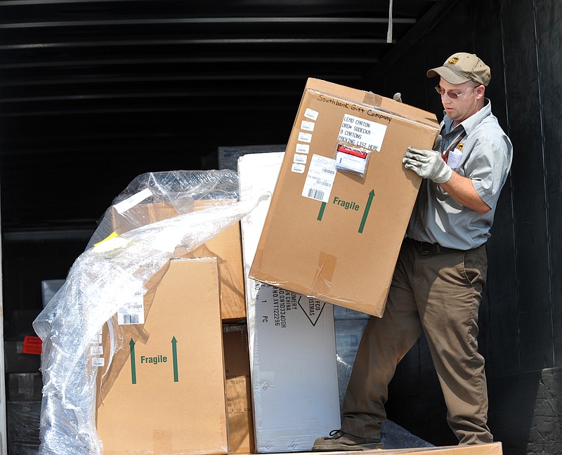 Jesse Bowers of United Parcel Service freight division unloads items from a truck to a downtown Jefferson City business. Effective next May 21, a national registry will list all certified medical examiners (doctors who perform physical examinations on truck drivers). Currently, only one Jefferson City physician holds that certification.