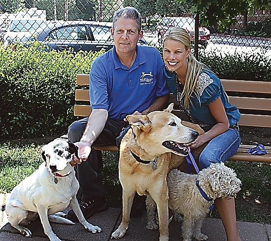 Michael Malloy, left, and NSALA volunteer and spokesperson Beth Stern, pose with dogs, left to right: Domino, Ivan and Joshua, in Port Washington, N.Y.  Domino, Ivan and Joshua arrived at New York's NSALA together. If they get adopted, it will be together again.