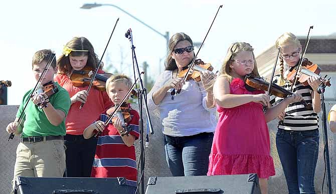 
Various members of the group "Pick, Strum & Bow" play their instruments as part of the entertainment at the Taste of Local Missouri held in the Old Munichberg section of Jefferson City on Saturday evening. From left are Jack Klebba, Allie Talbert, Levi Talbert, Rebecca Talbert, Cora Seawert and Aaron Talbert.