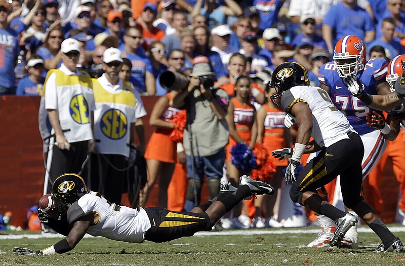 Missouri cornerback E.J. Gaines, shown here recovering a fumble during last season's game against Florida in Gainesville, Fla., will play Saturday after missing time in the preseason with a knee injury.