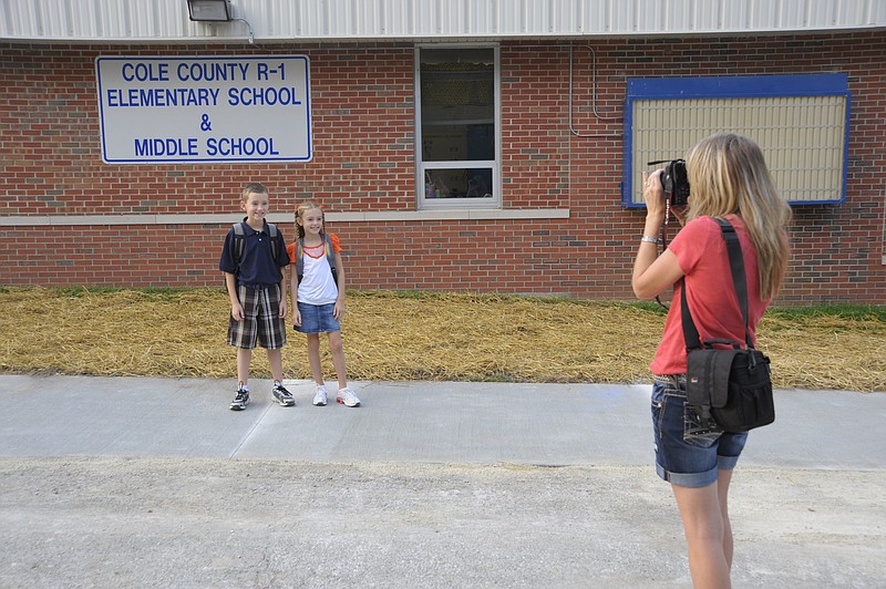 A long-standing tradition on the first day of school for the Plochberger family is photos at home and photos in front of the Cole County R-1 Elementary School sign. Mom Jamie Plochberger hoped the new year's pictures of fifth-grader Landon and second-grader Lexie would make it in the scrapbooks this weekend. Democrat staff/Michelle Brooks
