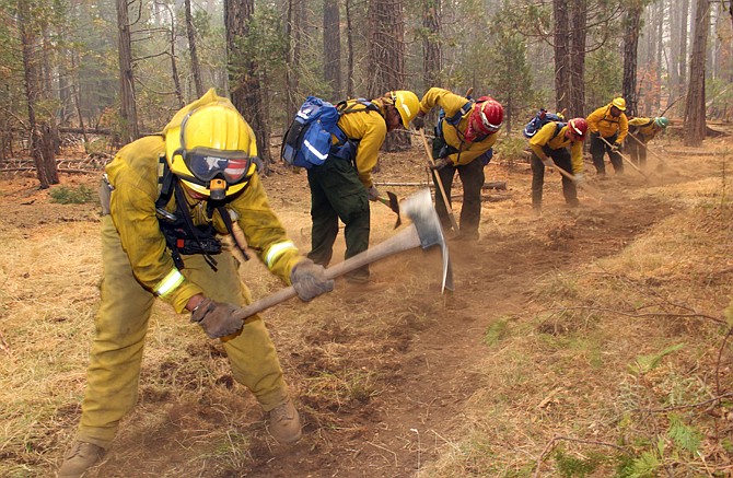 A fire crew digs a fire line near Yosemite National Park on Sunday. Firefighters continue to battle the Rim Fire, which had ravaged 282 square miles by Tuesday, the biggest in the Sierra's recorded history.