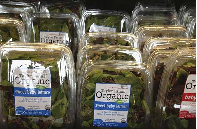 In this Aug. 3, 2013, file photo are packages of Taylor Farms salads for sale at a supermarket in Omaha, Neb.