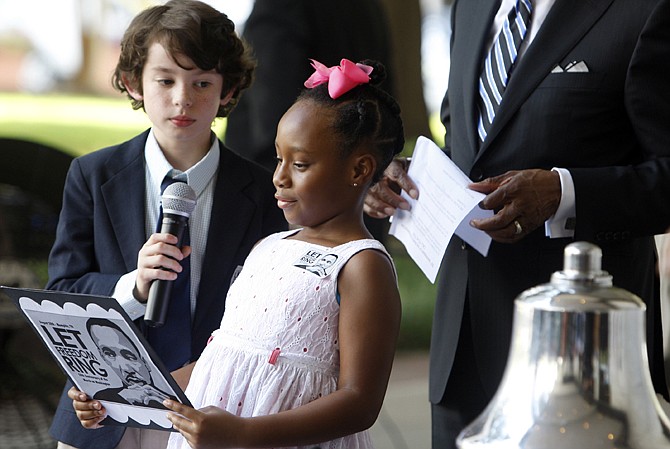 Jack Sullivan, 9, and Cailan Smith, 8, ring a bell as a crowd gathered outside of Memphis city hall on Wednesday to take part in the Let Freedom Ring celebration hosted by the mayor to mark the 50th anniversary of the March on Washington. Church bells rang out Wednesday at the National Cathedral and at sites nationwide to answer a call from one of the most important civil rights speeches in history to "let freedom ring." 