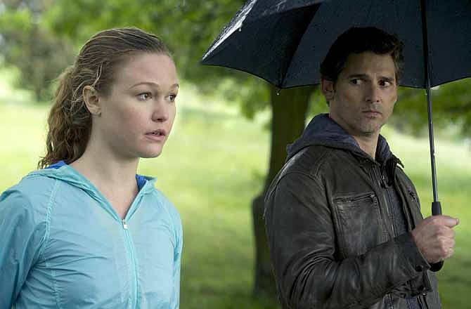 This film image released by Focus Features shows Julia Stiles, left, and Eric Bana in a scene from "Closed Circuit." 