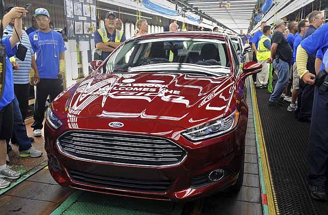 A new 2014 Ford Fusion is displayed on the line in Flatrock, Mich. on Thursday, Aug. 29, 2013. For the first time, Ford is making its Fusion sedan in the U.S. The company's Flat Rock, Mich., plant began making the Fusion on Thursday.