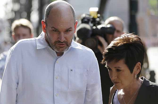 In this April 9, 2013, file photo, former NFL player Kevin Turner accompanied by Lisa McHale, the widow of former NFL player Tom McHale, walk to the U.S. Courthouse Tuesday, in Philadelphia for a hearing to determine whether the NFL faces years of litigation over concussion-related brain injuries. Judge Anita Brody has announced on Thursday, Aug. 29, 2013 that the NFL and more than 4,500 former players want to settle concussion-related lawsuits for $765 million.
