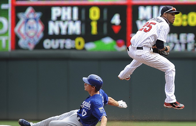 Twins shortstop Pedro Florimon jumps to avoid the slide of the Royals' Chris Getz during the fourth inning of Thursday's game in Minneapolis.