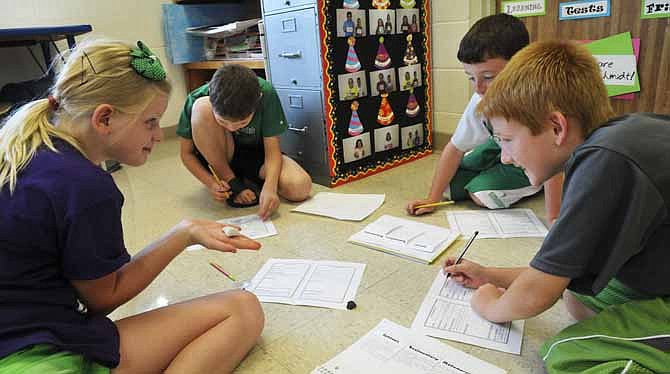 
Students in Aimee Schmidt's fourth grade classroom at Blair Oaks Elementary School learn about types of rocks Friday. Clockwise from left are Peyton Bohl, Dex Crane, Cadon Garber and Sean Meyer.