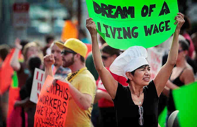  In this Aug. 29, 2013, file photo, Christina Condori joins a crowd of fast-food workers and their supporters in protest, while picketing outside of a McDonald's restaurant in Memphis, Tenn.  (AP Photo/The Commercial Appeal, Jim Weber, File)