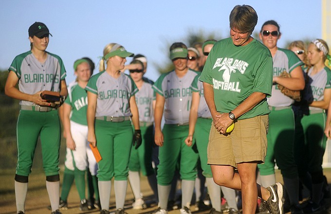 Blair Oaks head softball coach Sharon Buschjost smiles while being honored for her 300th career victory following the Lady Falcons' win Tuesday against Russellville at the Falcon Athletic Complex.