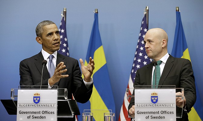 President Barack Obama, accompanied by Swedish Prime Minister Fredrik Reinfeldt, gestures Wednesday during their joint news conference at the Rosenbad Building in Stockholm, Sweden. 