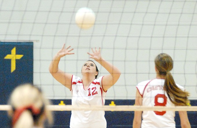Emily Layson of the Calvary Lutheran Lady Lions sets the ball for a teammate during their match Thursday night against the Belle Lady Tigers at Trinity Lutheran Gymnasium.