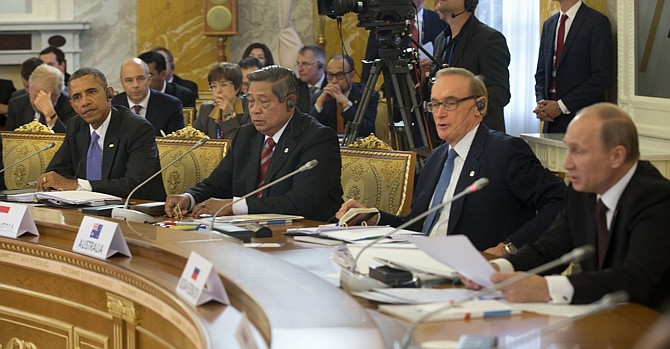 President Barack Obama listens as Russian President Vladimir Putin, far right, speaks Thursday during the start of the G-20 Working Session at the Konstantin Palace in St. Petersburg, Russia. From left are, Obama, Indonesian President Susilo Bambang Yudhoyono, Australian Foreign Minister Bob Carr and Putin.