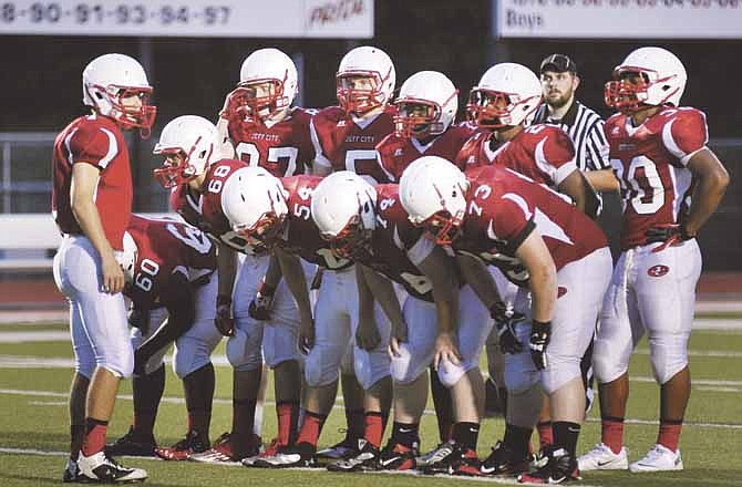 The Jefferson City Jays offense, shown here in a huddle during a scrimmage at Adkins Stadium, racked up 24 points in one half on Aug. 31 to open the 2013 season against McCluer North.