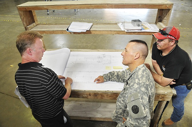 Charles Machon, left, goes over architect plans for new museum space with Maj. Alan Brown and Doug Sheley. Machon, the director of the Museum of Missouri Military History, works with Brown, military historian, and Sheley, a volunteer, to come up with the best ideas for display locations and layouts. 