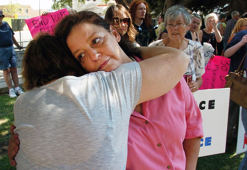 Auliea Hanlon receives a hug Thursday from a supporter during a rally in which protesters called for the resignation of a judge who presided over the trial of a former teacher who raped Hanlon's daughter. Hanlon rejected Judge G. Todd Baugh's apology for his comment that her daughter was "older than her chronological age" before sentencing the rapist to 30 days in prison.