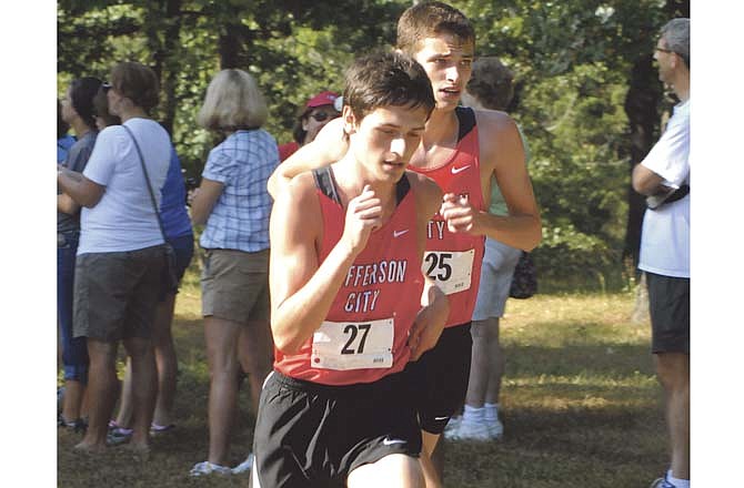 Jefferson City's Will Pierce (27) and Jack Gamble (25) head back up the hill toward the last loop of the course Saturday at the Cole County Park in the Jim Marshall Invitational.