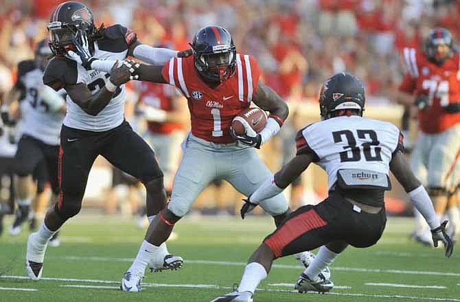Mississippi receiver Laquon Treadwell (1) stiff-arms Southeast Missouri State safety Ben Kargbo (21) while approaching Southeast Missouri State cornerback Reggie Jennings (32) during the first half of their NCAA college football game on Saturday, Sept. 7, 2013, in Oxford, Miss.